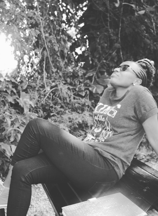 A woman resting quietly in a garden, looking upward